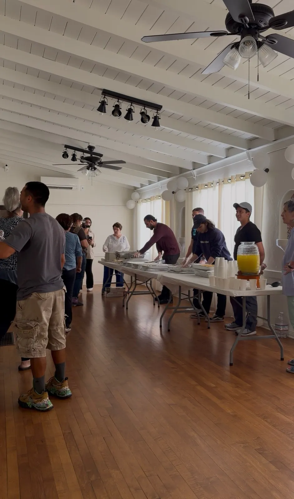 Guests lined up at the serving tables inside the Arcadia Women's Clubhouse