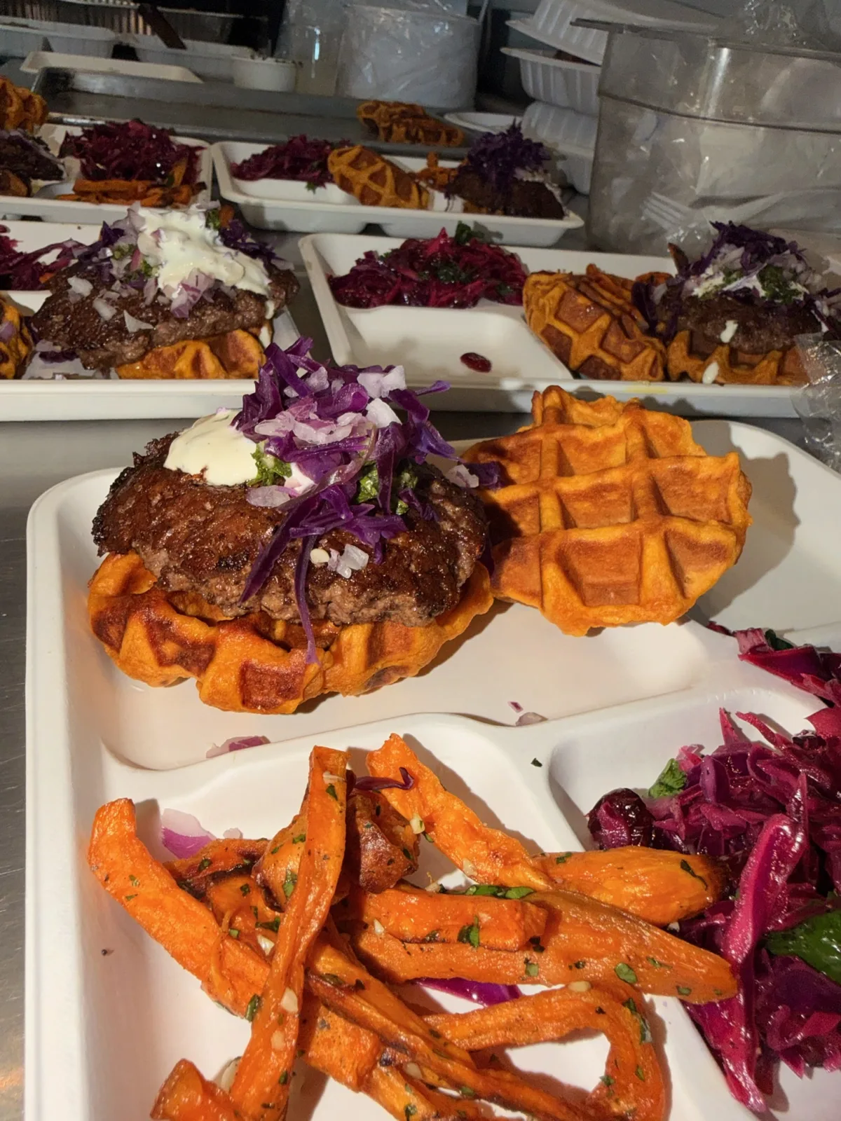 Multiple burger plates lined up ready to serve at Union Station Homeless Services