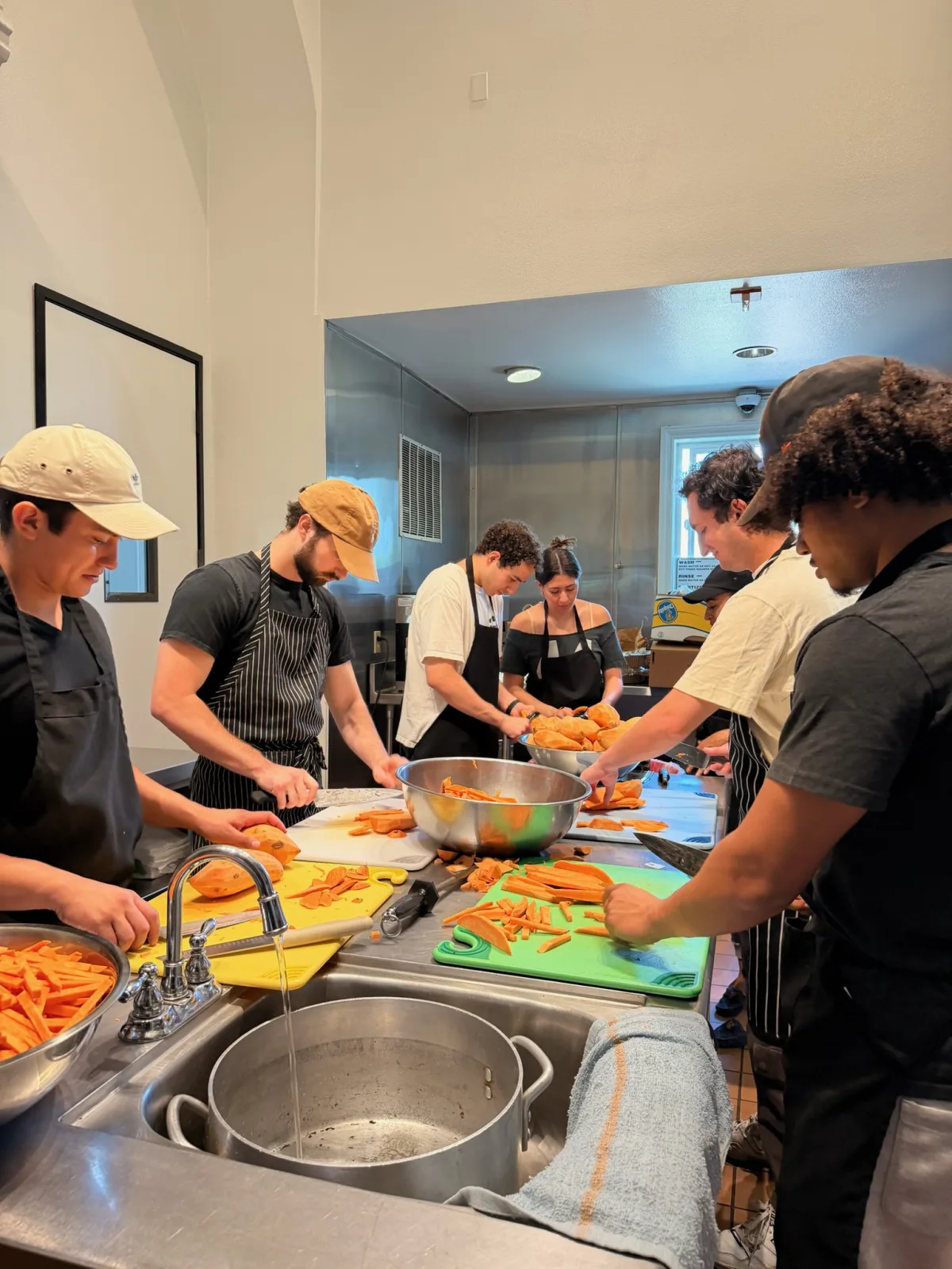 Seed to Serve LA volunteers cutting sweet potato fries at the prep station