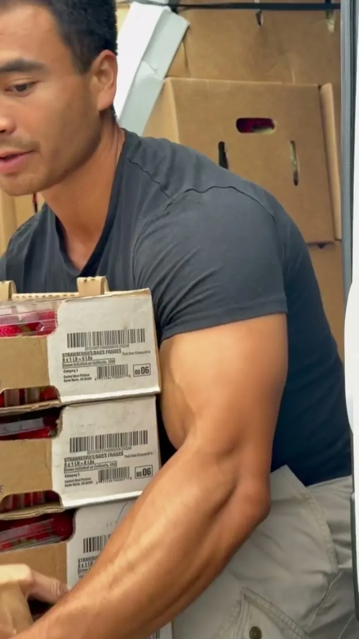 Kole Lim of Seed to Serve LA carrying stacked boxes of produce during a pickup